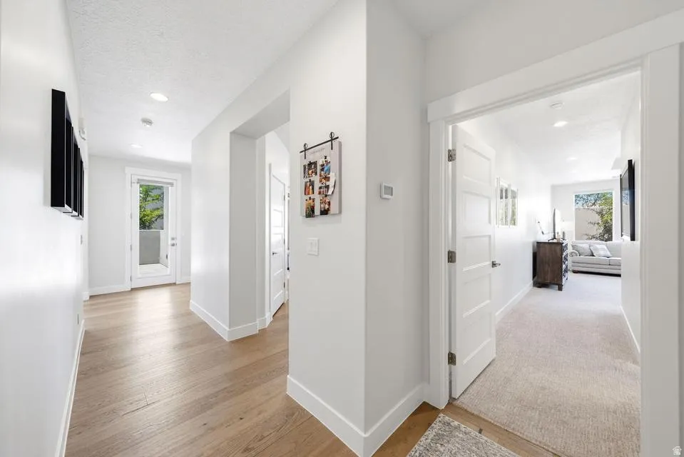 Hallway featuring light wood finished floors and recessed lighting