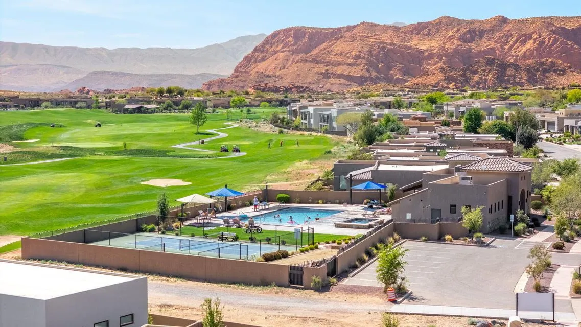 Aerial view of residential area with mountains and a local golf course
