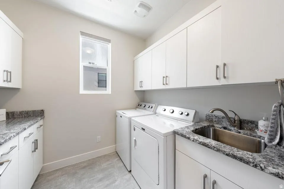 Laundry room with cabinet space and separate washer and dryer