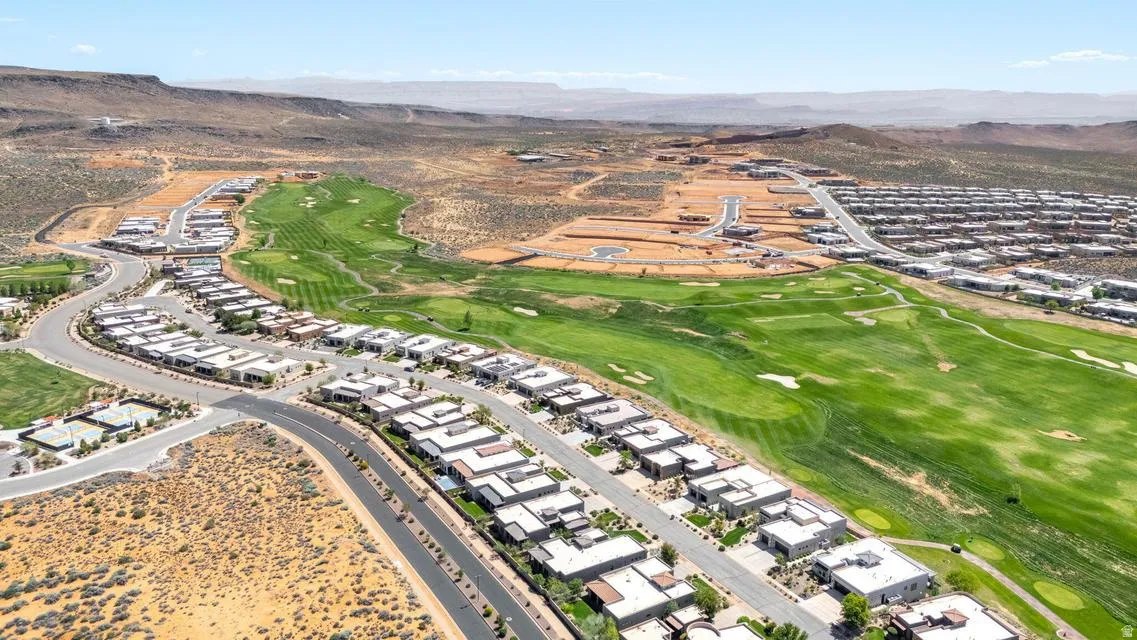 Aerial view of property's location with mountains and a golf course
