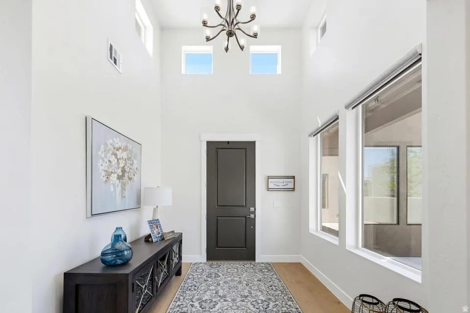 Entryway with hanging lights and light wood-type flooring