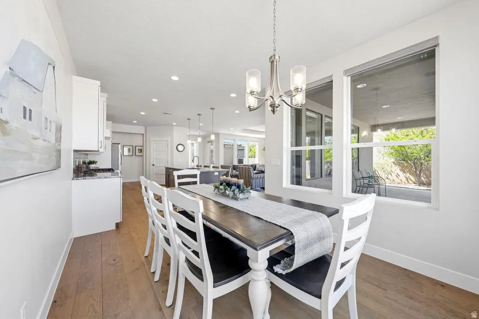 Dining area with light wood-type flooring and hanging lights