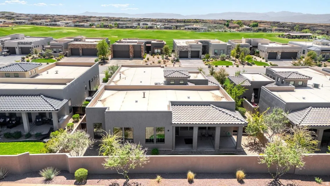 Aerial perspective of suburban area with mountains and a golf course