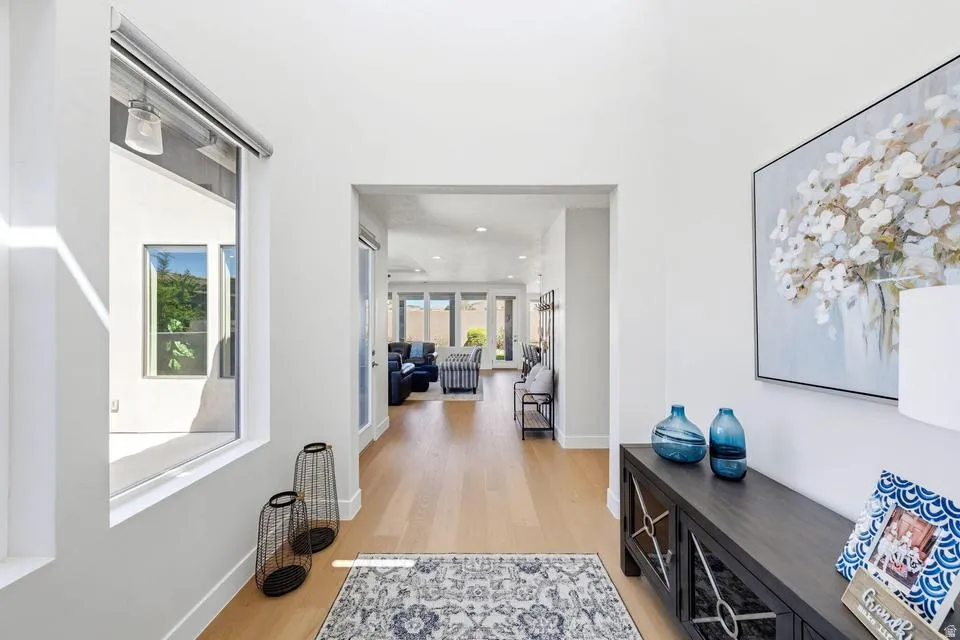 Hall featuring light wood-style floors and baseboards