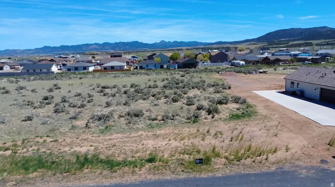 View of mountain backdrop featuring nearby suburban area