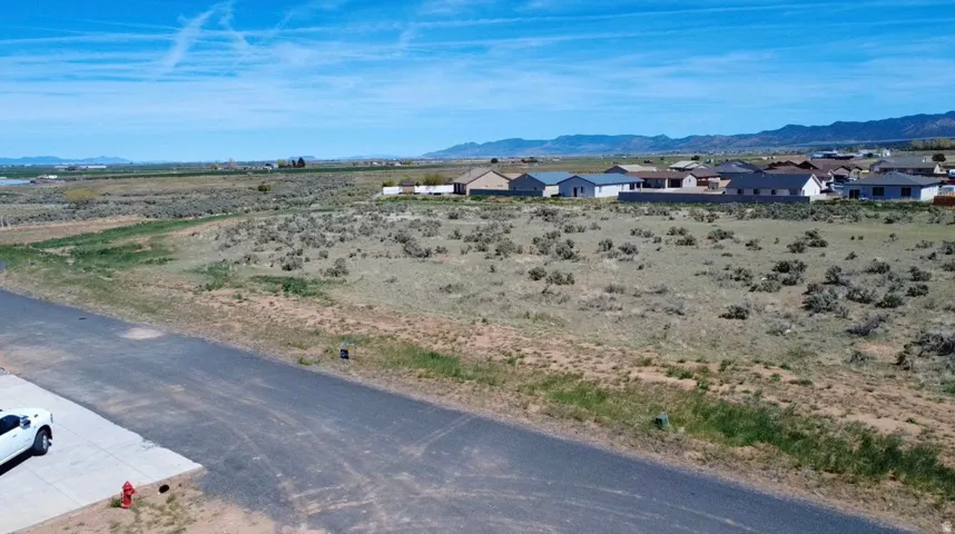 View of mountain backdrop featuring nearby suburban area