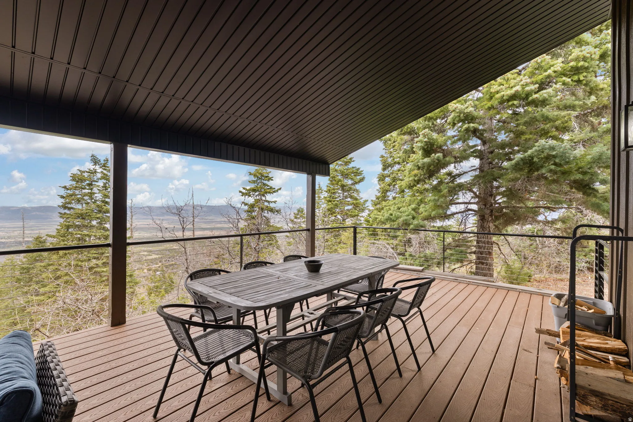 Cabin 1 - West; Deck with outdoor dining space and a mountain view