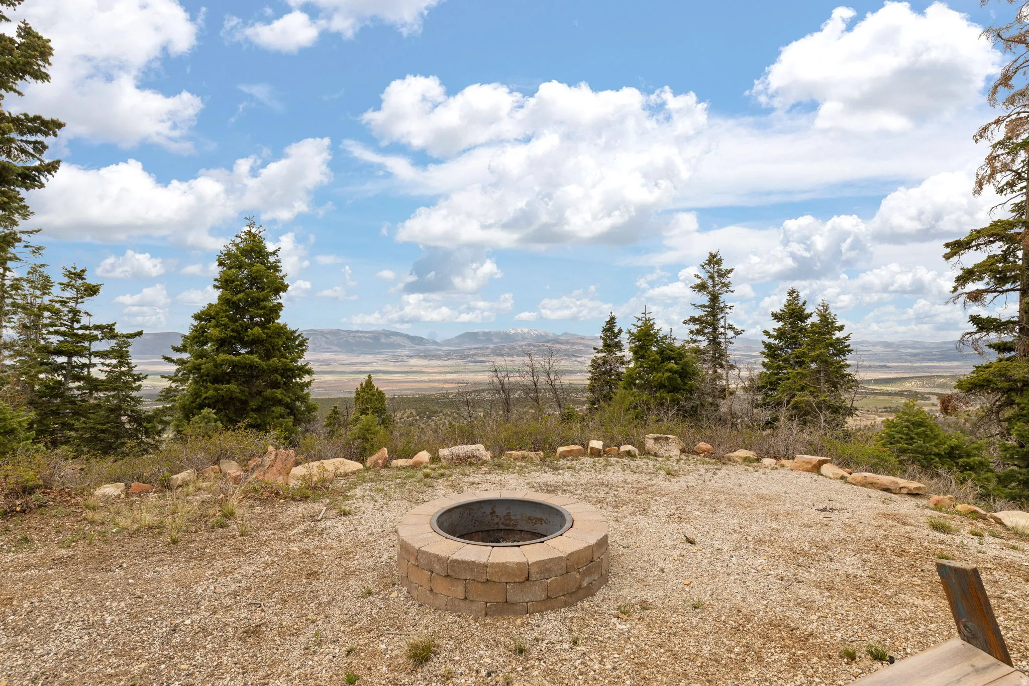 View of yard featuring a fire pit, a mountain view, and a view of countryside