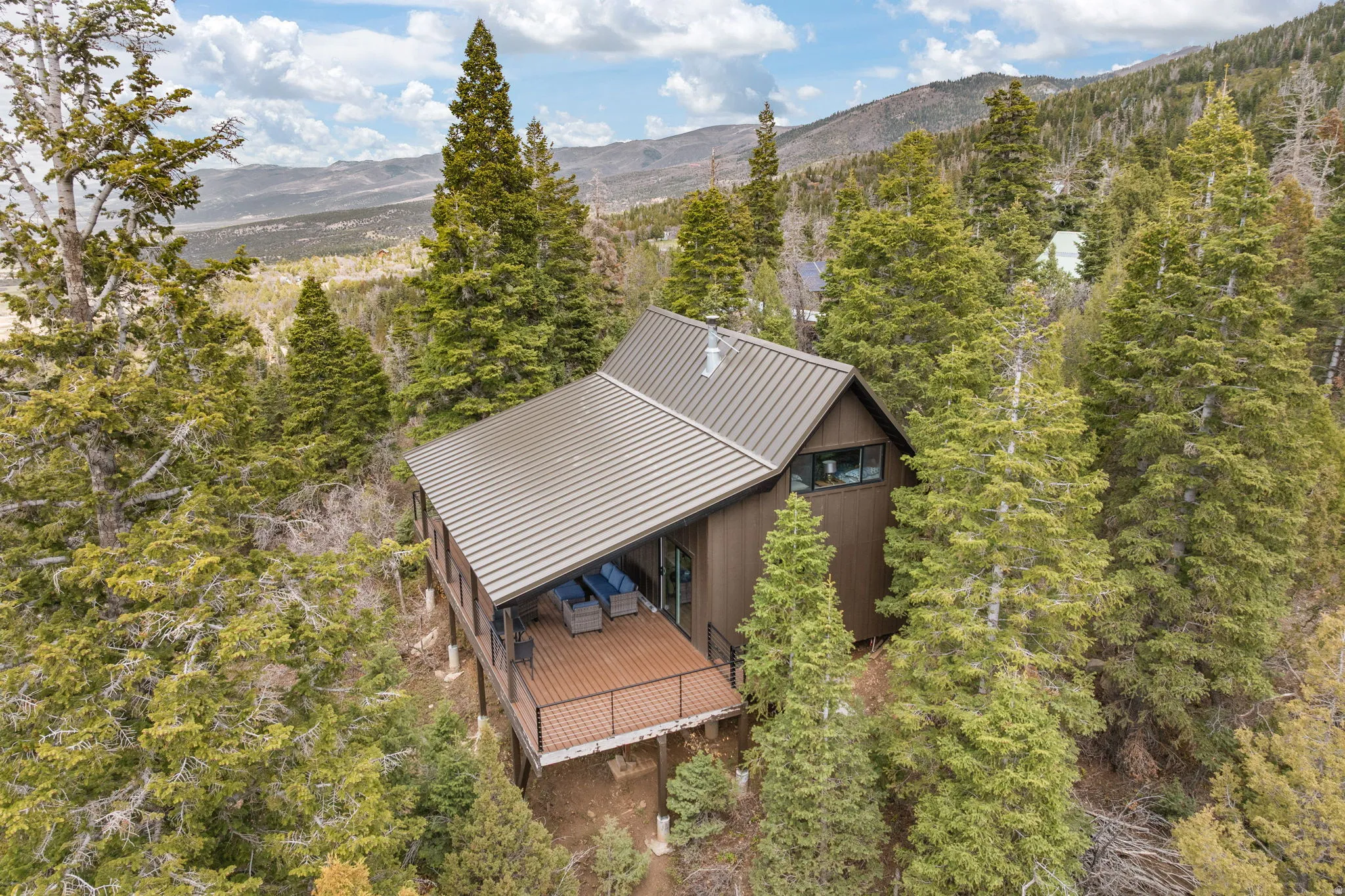 Cabin 1 - West; View of subject property featuring a mountainous background and a heavily wooded area