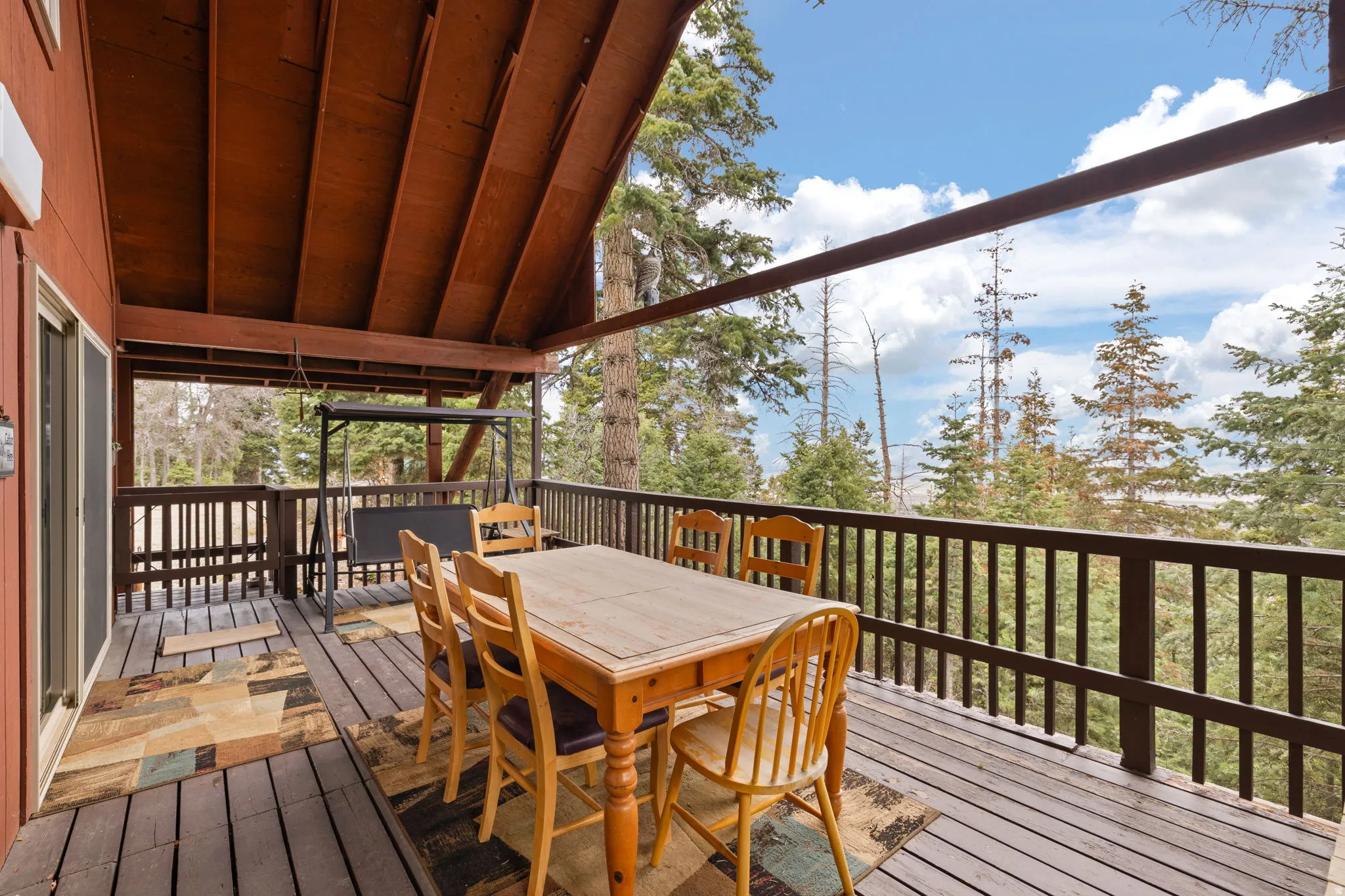 Cabin 2 - East; Wooden terrace featuring outdoor dining area