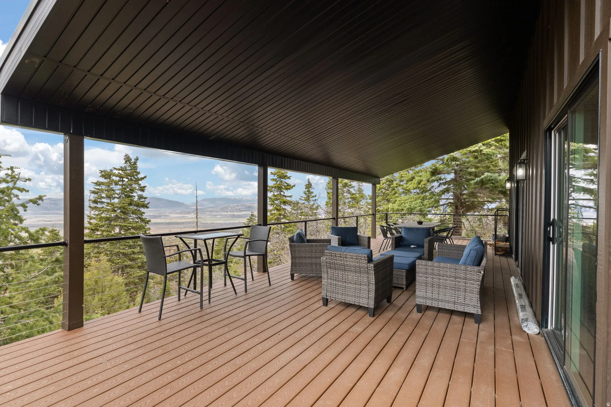Cabin 1 - West; Wooden deck featuring an outdoor hangout area and a mountain view