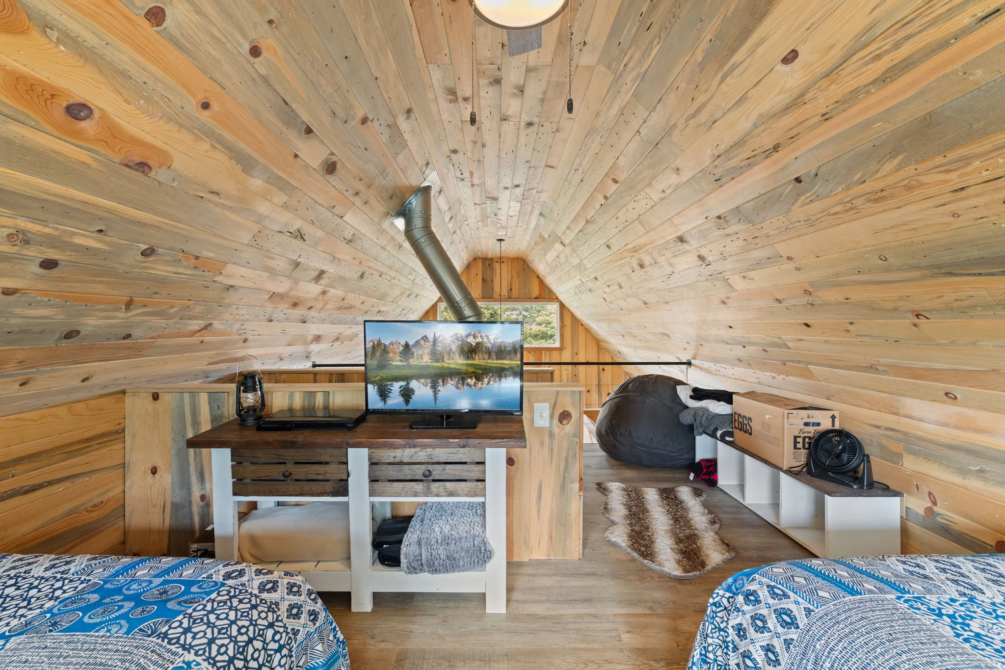 Cabin 1 - West; Upstairs loft/Bedroom featuring wood walls, a vaulted wooden ceiling, and wood finished floors