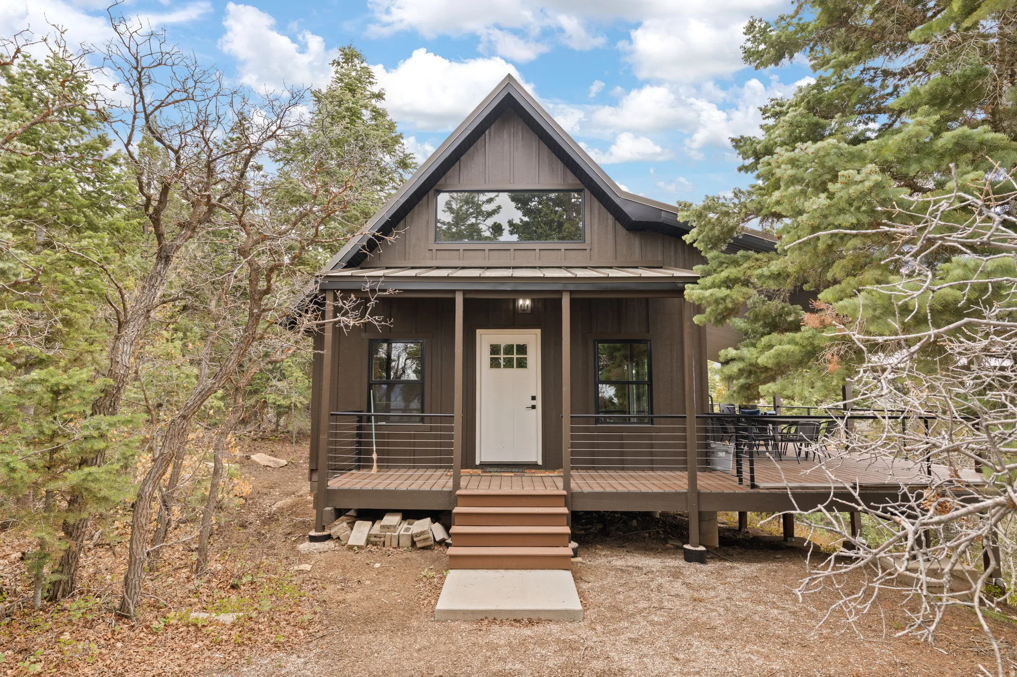 Cabin 1 - West; inviting front porch with wrap around deck