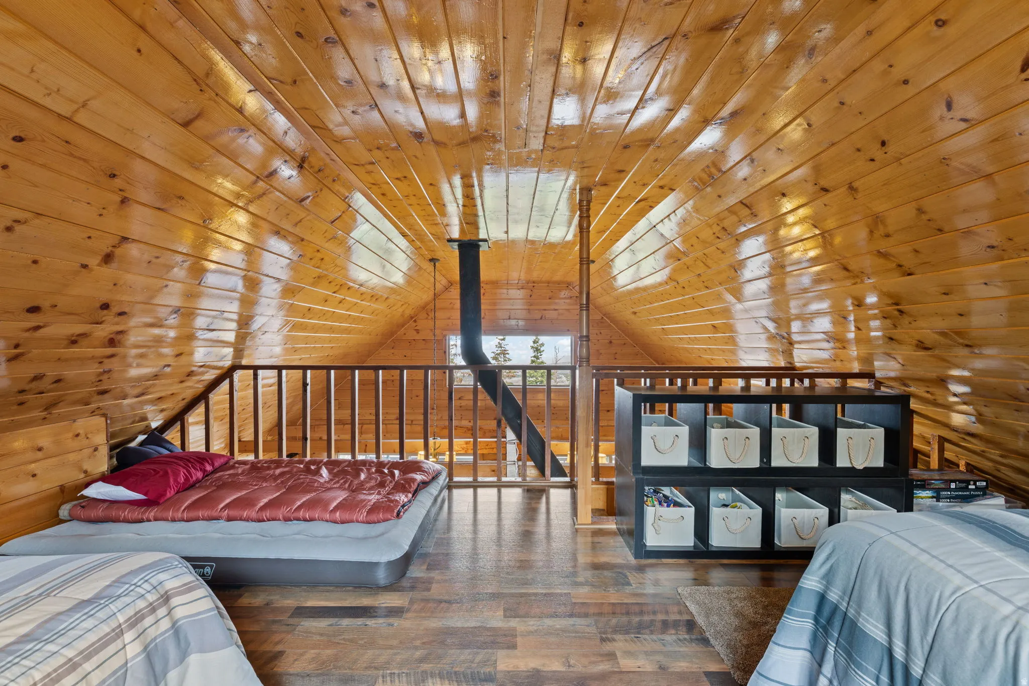 Cabin 2 - East; Loft/Bedroom featuring hardwood / wood-style floors, wooden walls, and wood ceiling