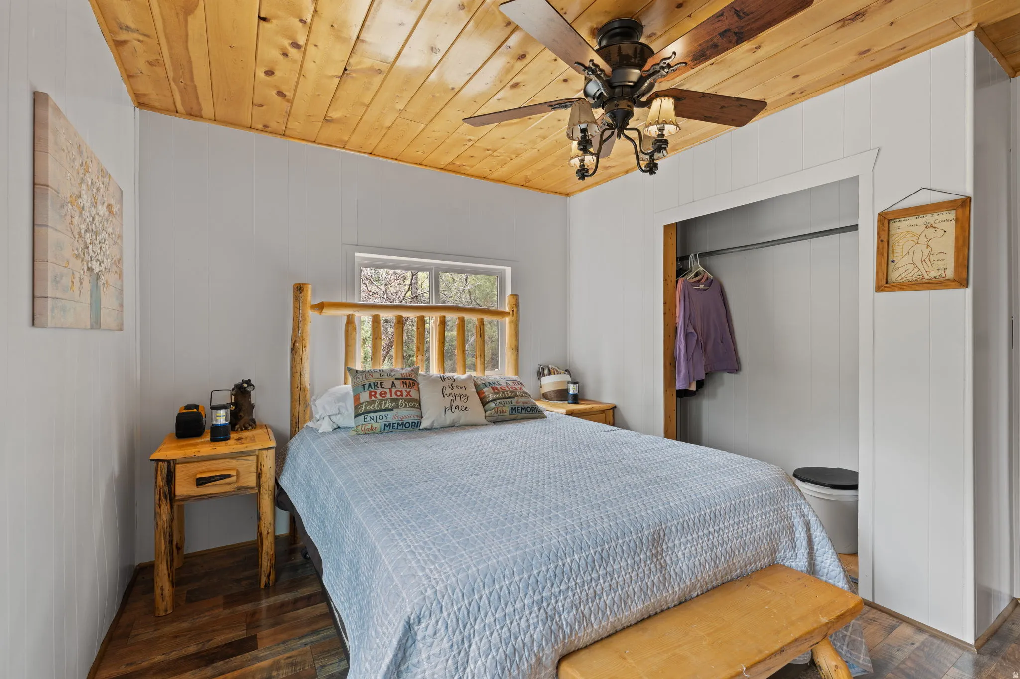 Cabin 2 - East; Bedroom with wooden ceiling, a closet, a ceiling fan, and dark wood-type flooring