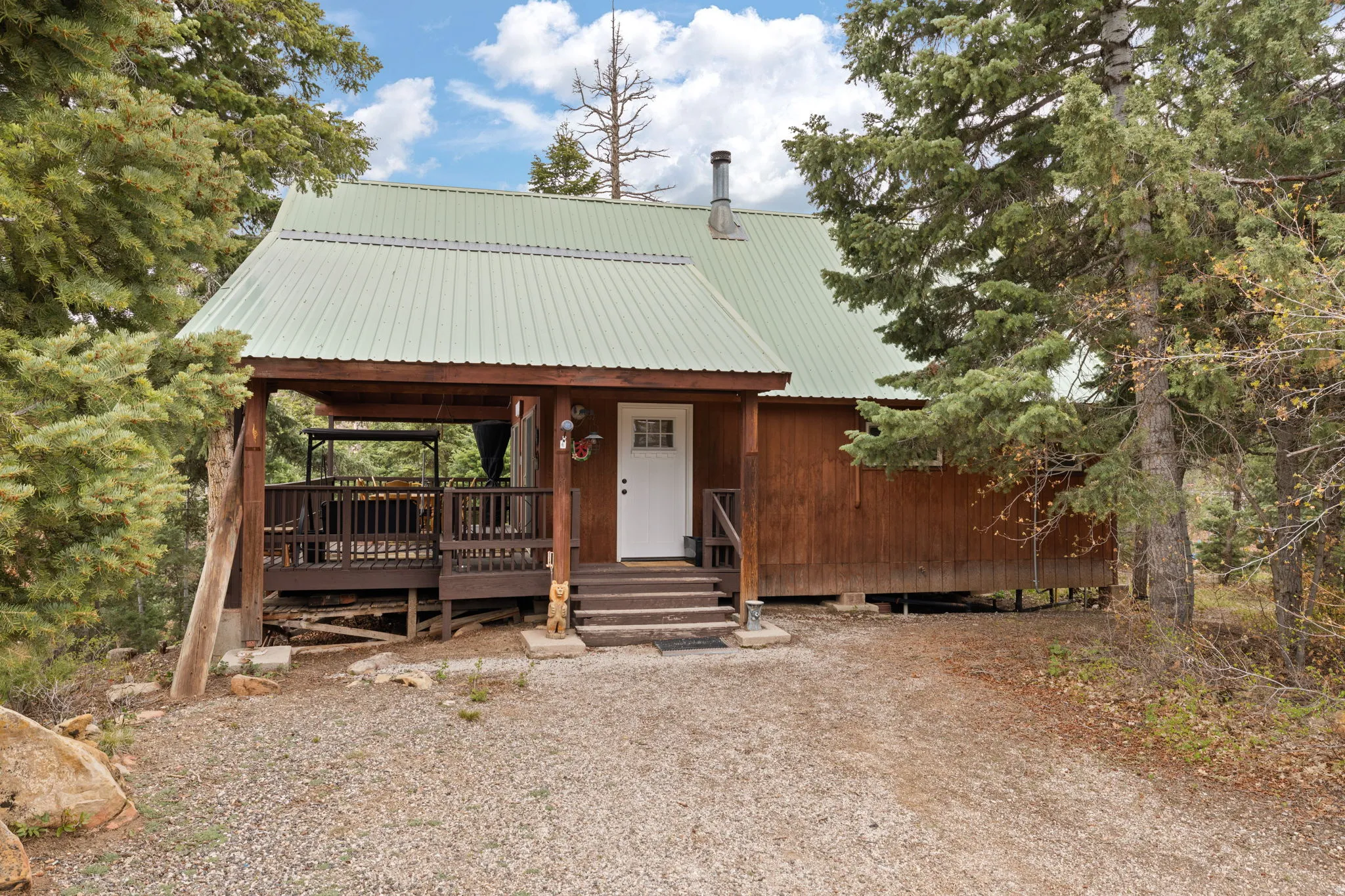 Cabin 2 - East; Chalet / cabin featuring a metal roof and covered porch