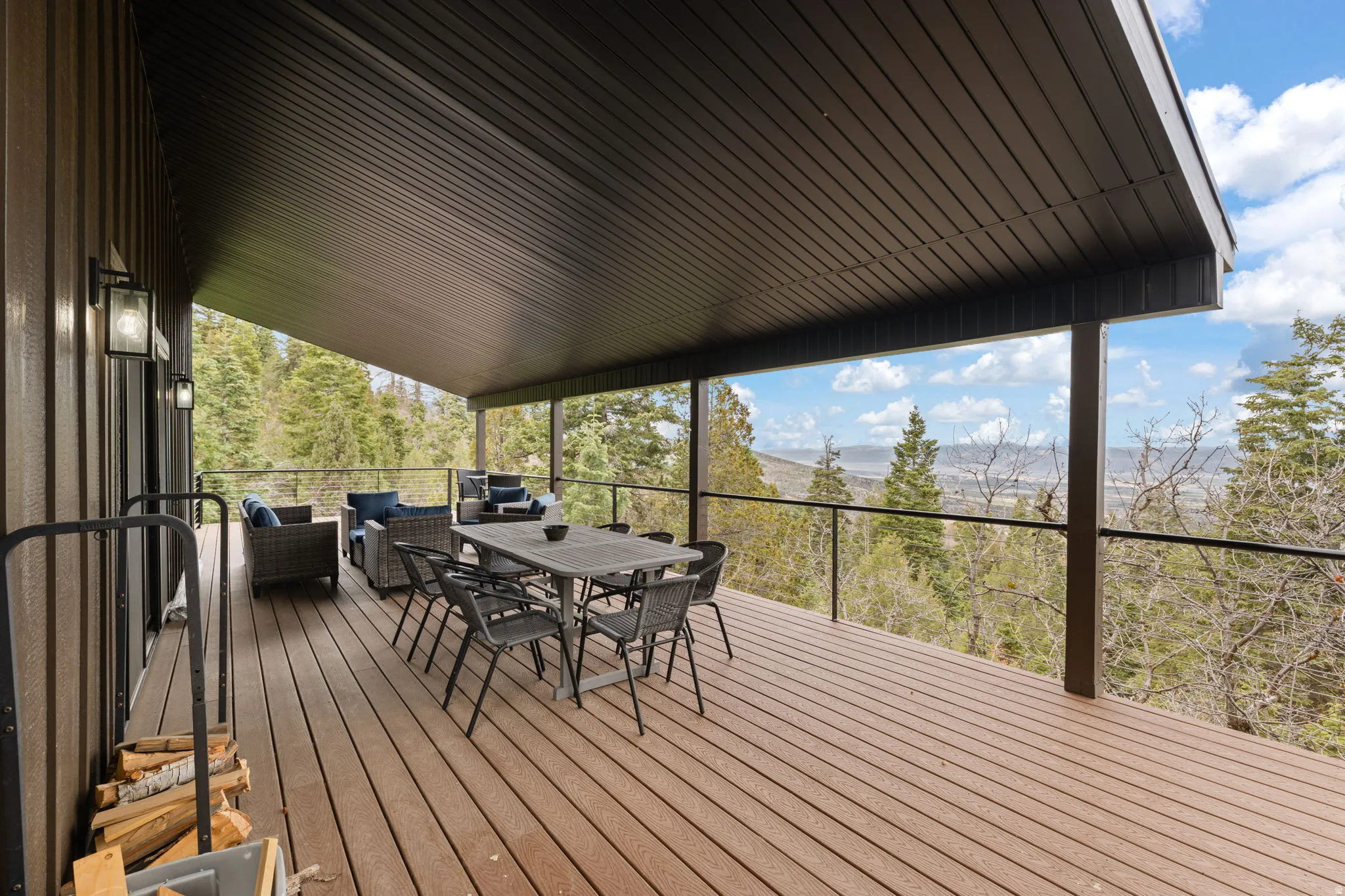 Cabin 1 - West; Wooden deck with outdoor lounge area and a mountain view