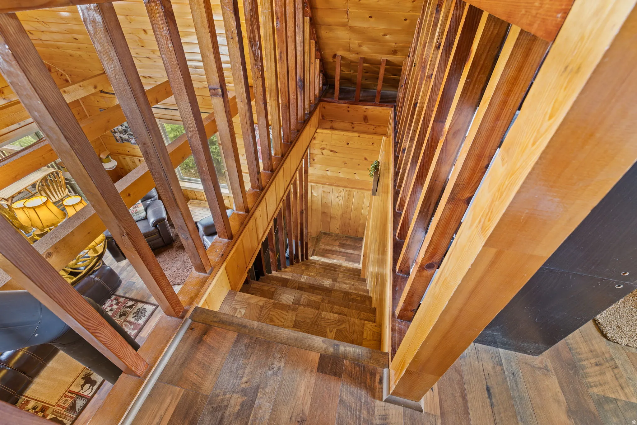 Cabin 2 - East; Staircase with hardwood / wood-style flooring and wooden walls