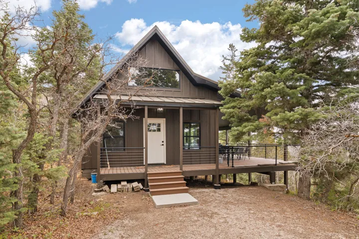 Cabin 1 - West; inviting front porch with wrap around deck