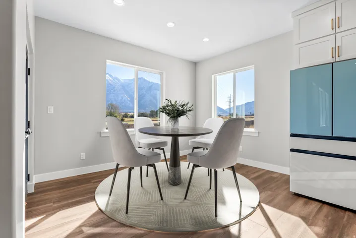 Dining space with a mountain view, wood finished floors, and recessed lighting