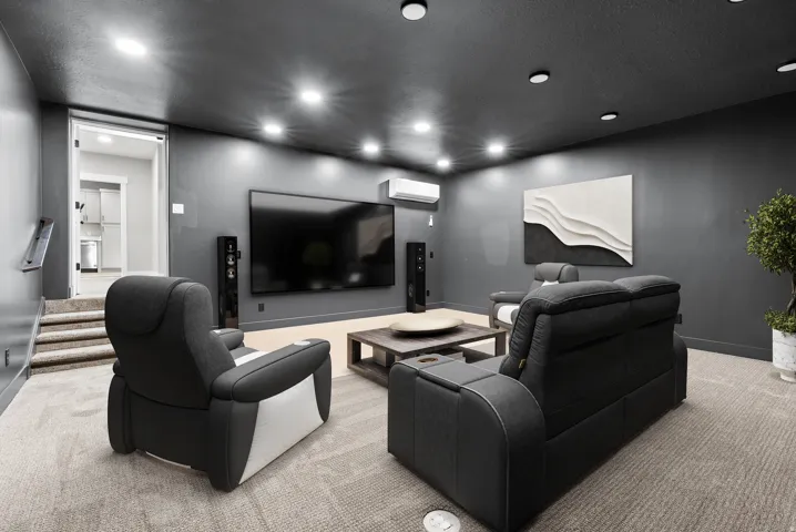 Home theater featuring light carpet, a textured ceiling, and recessed lighting