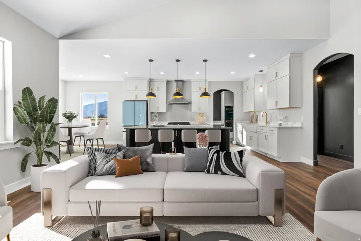 Living area with arched walkways, dark wood-style flooring, recessed lighting, and vaulted ceiling