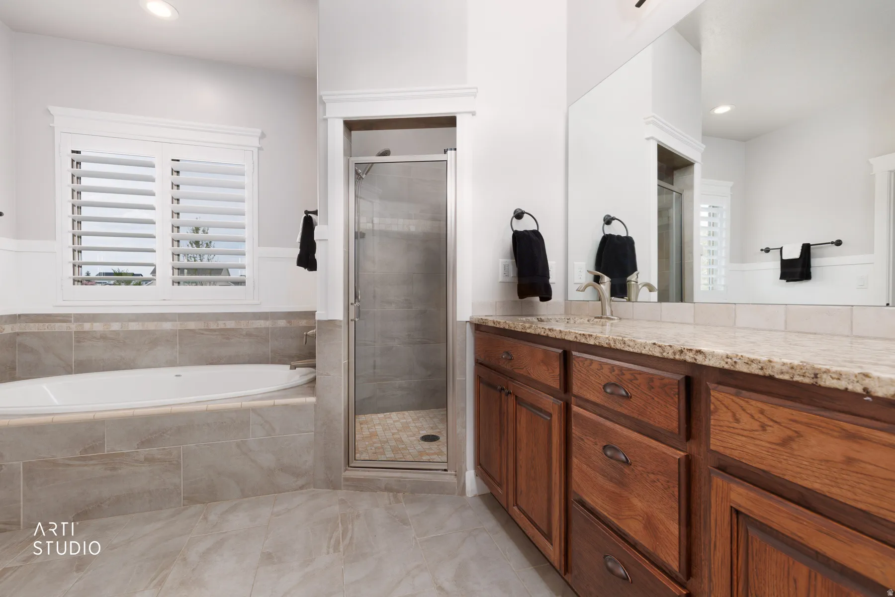Bathroom with vanity, a stall shower, a garden tub, and recessed lighting