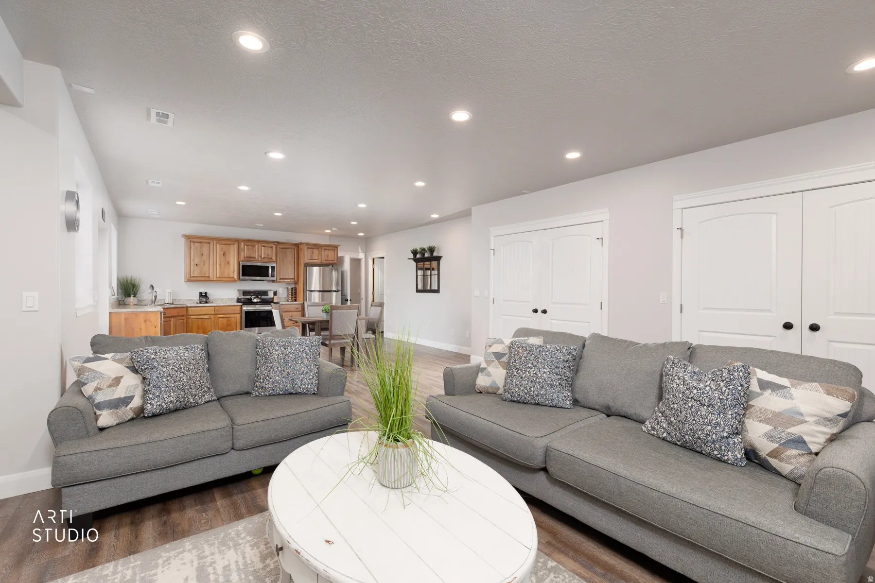 Living room with wood finished floors and recessed lighting