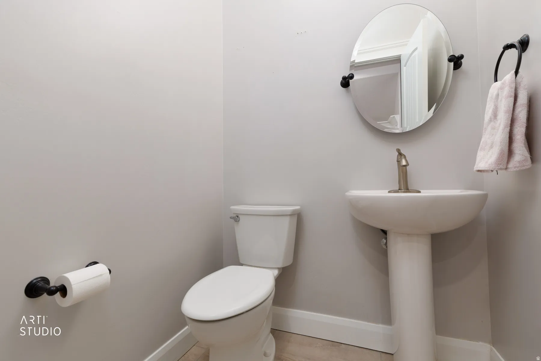 Half bathroom with baseboards and toilet