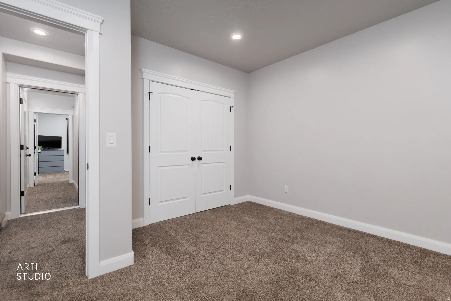 Unfurnished bedroom featuring dark carpet, a closet, and recessed lighting