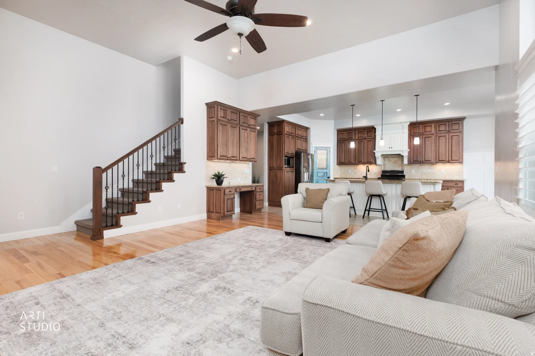 Living area featuring a ceiling fan, light wood-style floors, and recessed lighting