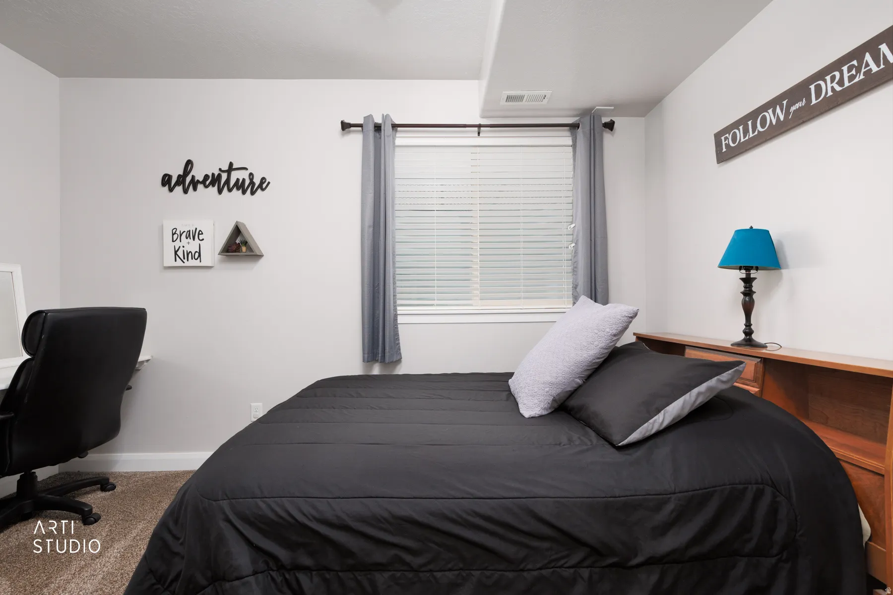 Bedroom featuring carpet flooring and a desk