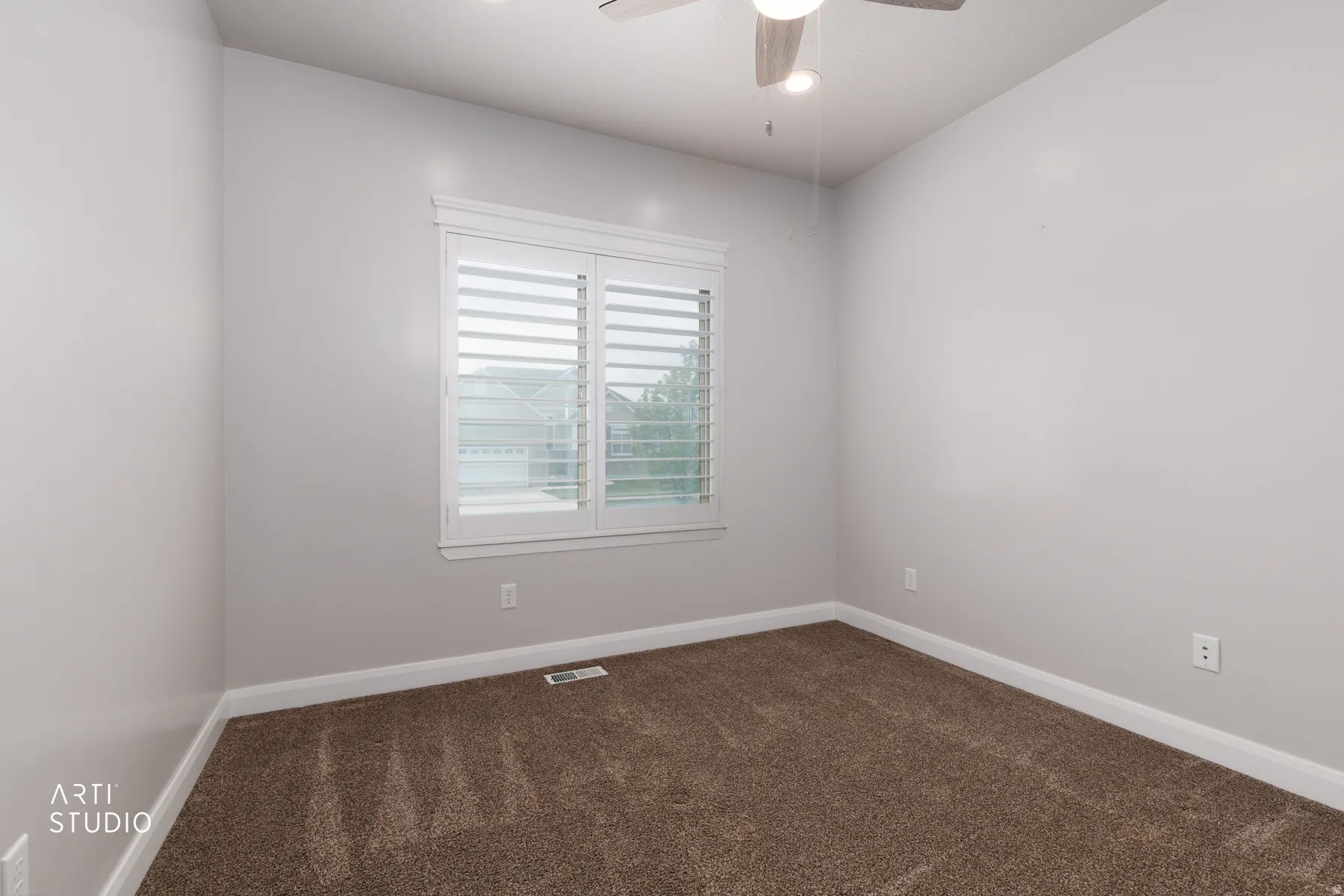 Spare room with dark carpet and ceiling fan