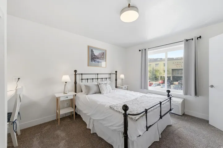Carpeted bedroom featuring baseboards