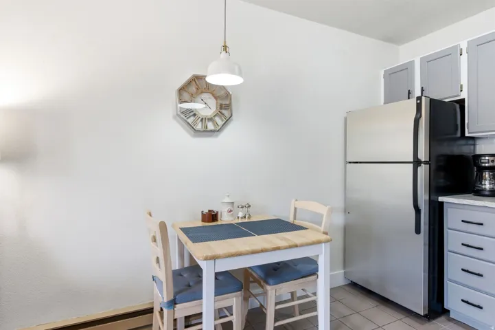 Dining area featuring a baseboard heating unit and light tile patterned flooring