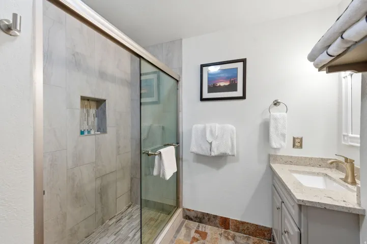 Full bathroom with vanity and a stall shower