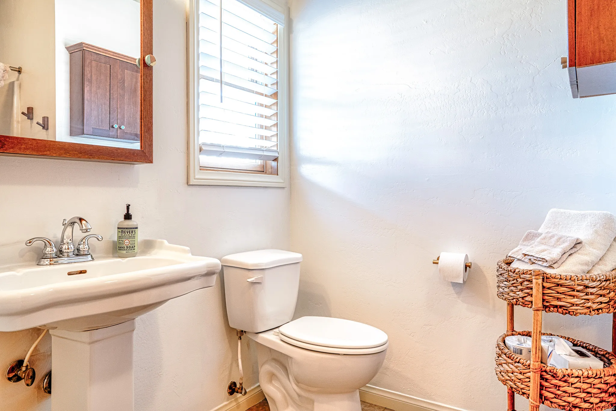 Half bathroom featuring toilet and baseboards