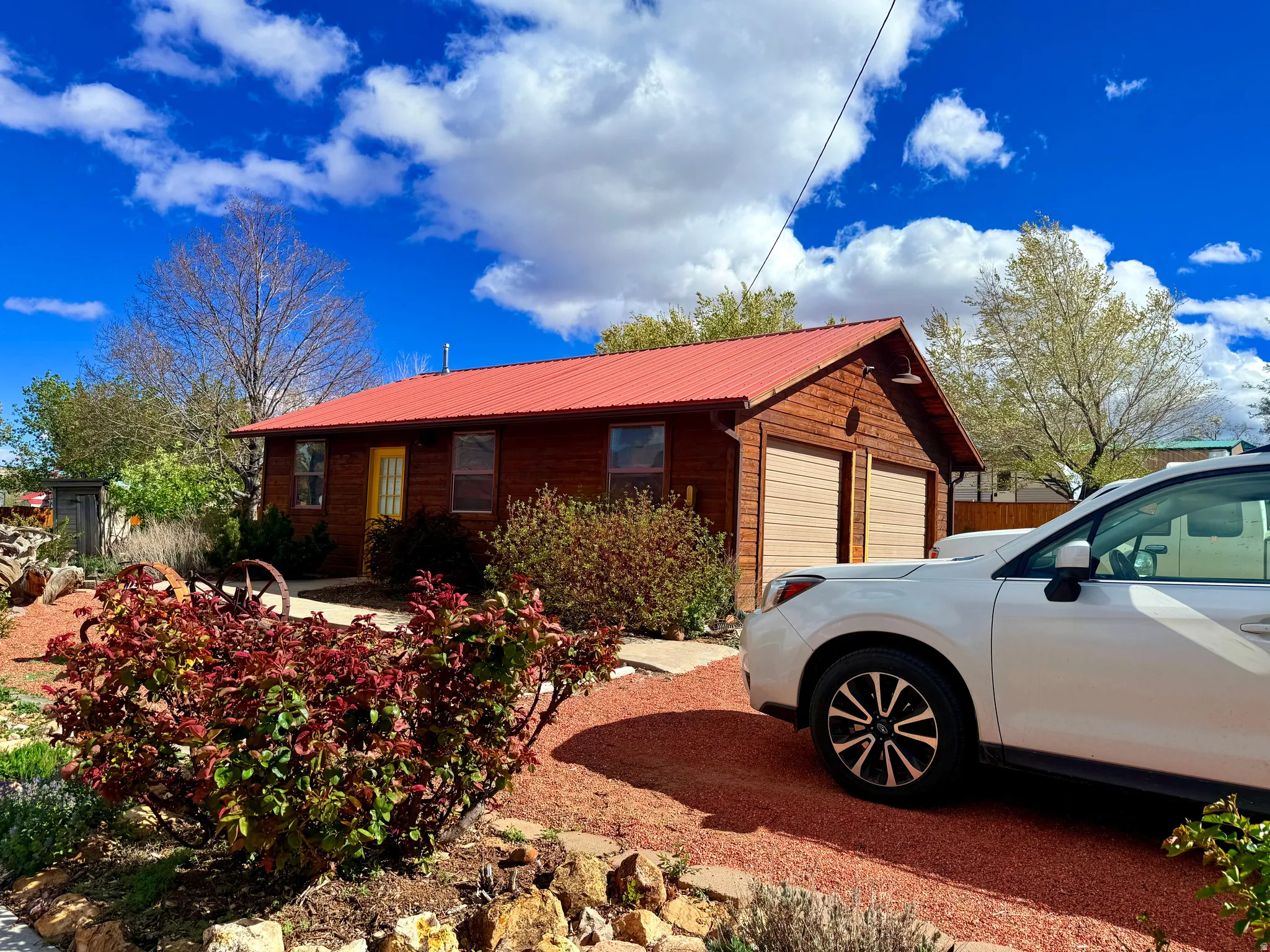 View of front of house featuring a metal roof and a garage