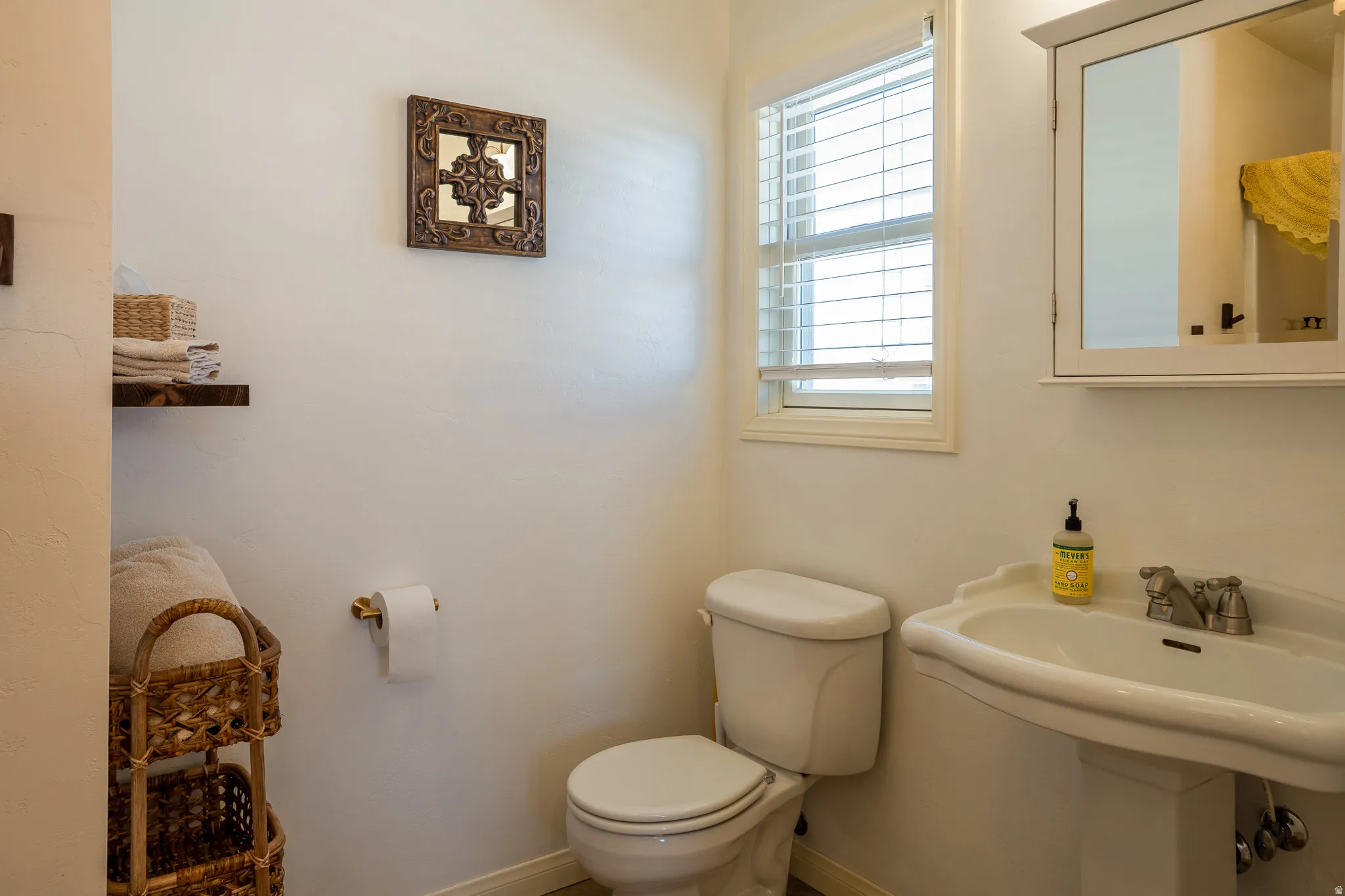 Half bathroom with toilet and baseboards