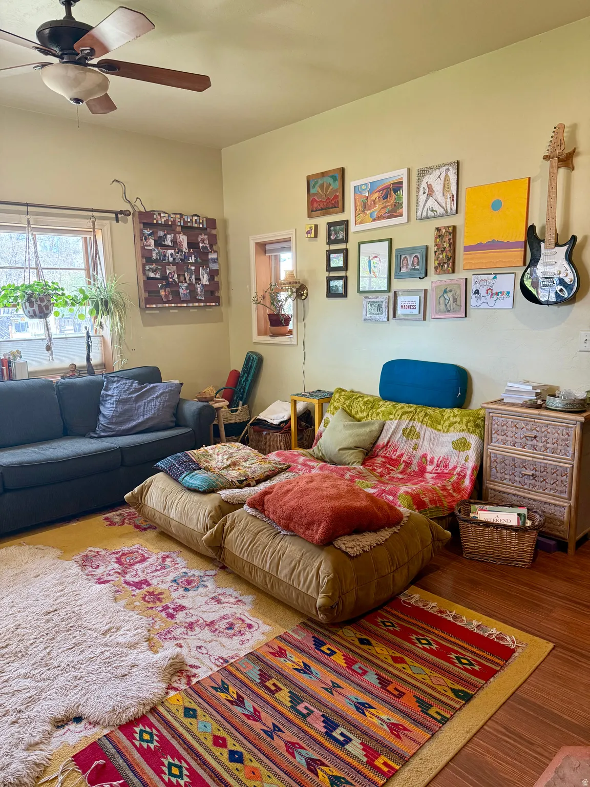 Living room featuring wood finished floors and a ceiling fan