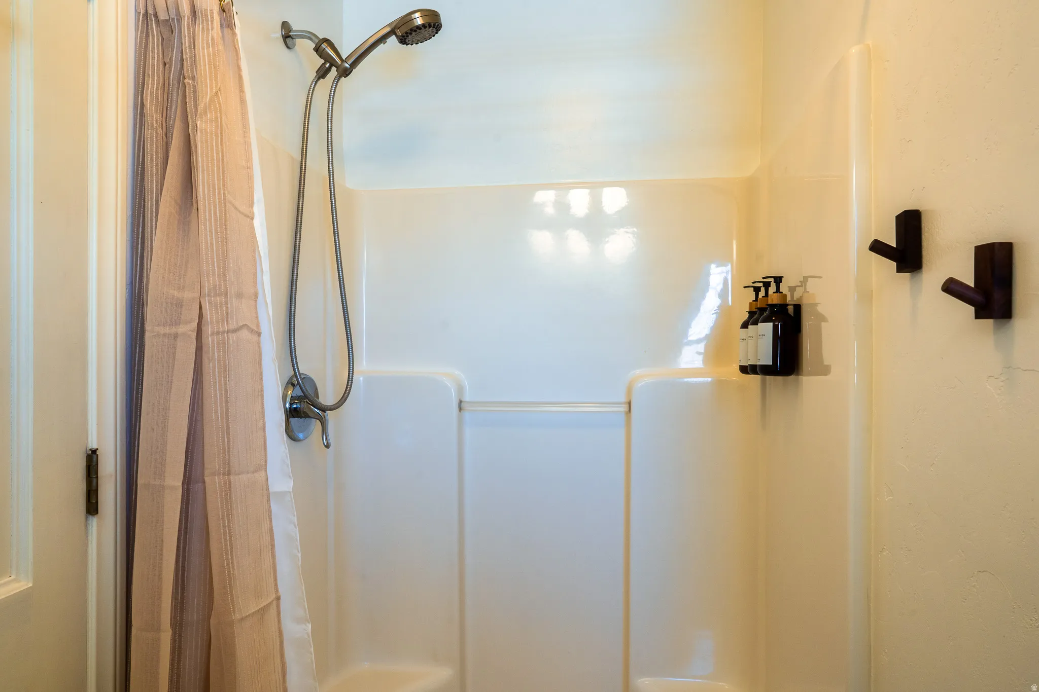 Bathroom with a shower with shower curtain