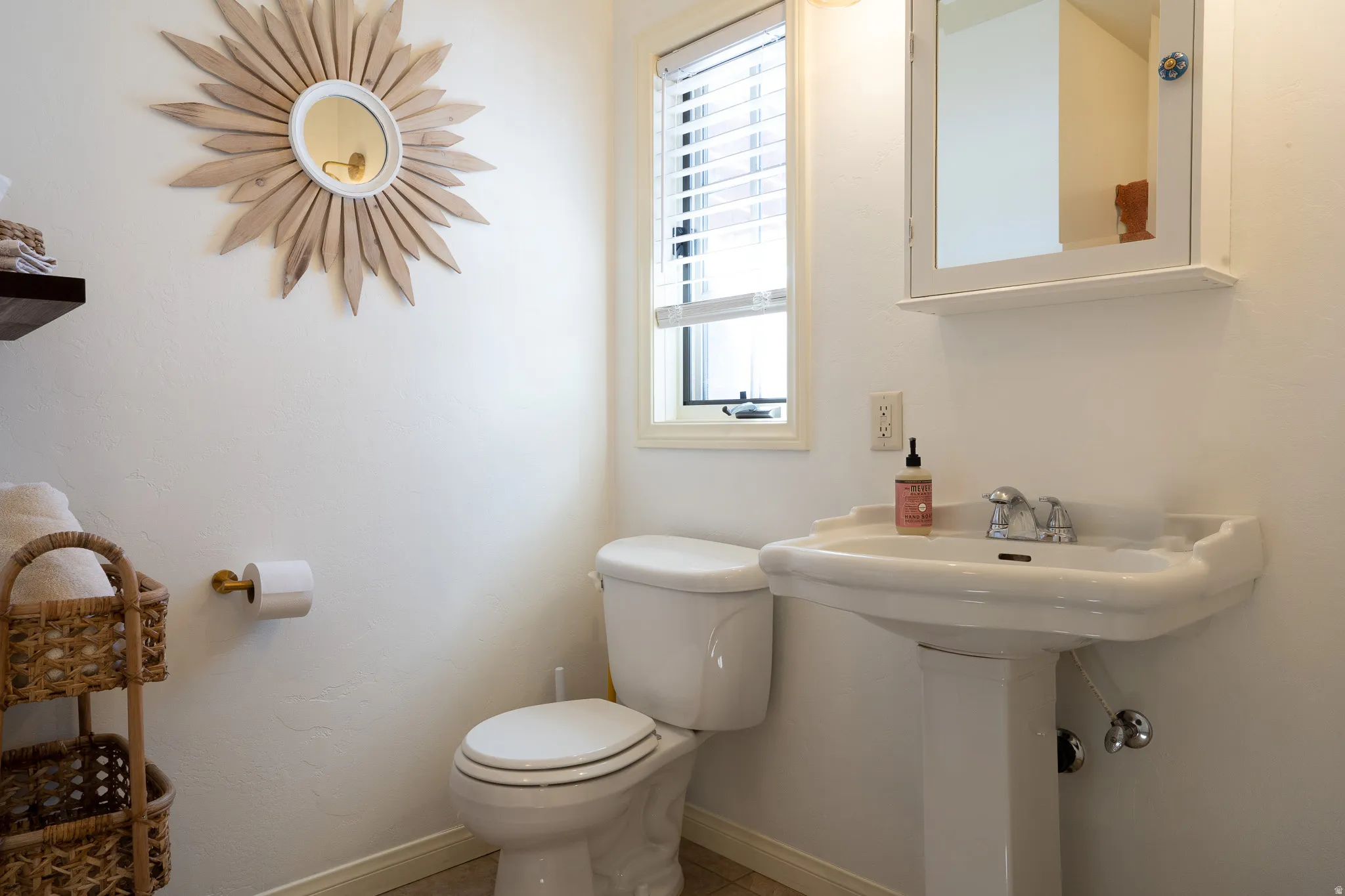 Half bath with toilet and baseboards