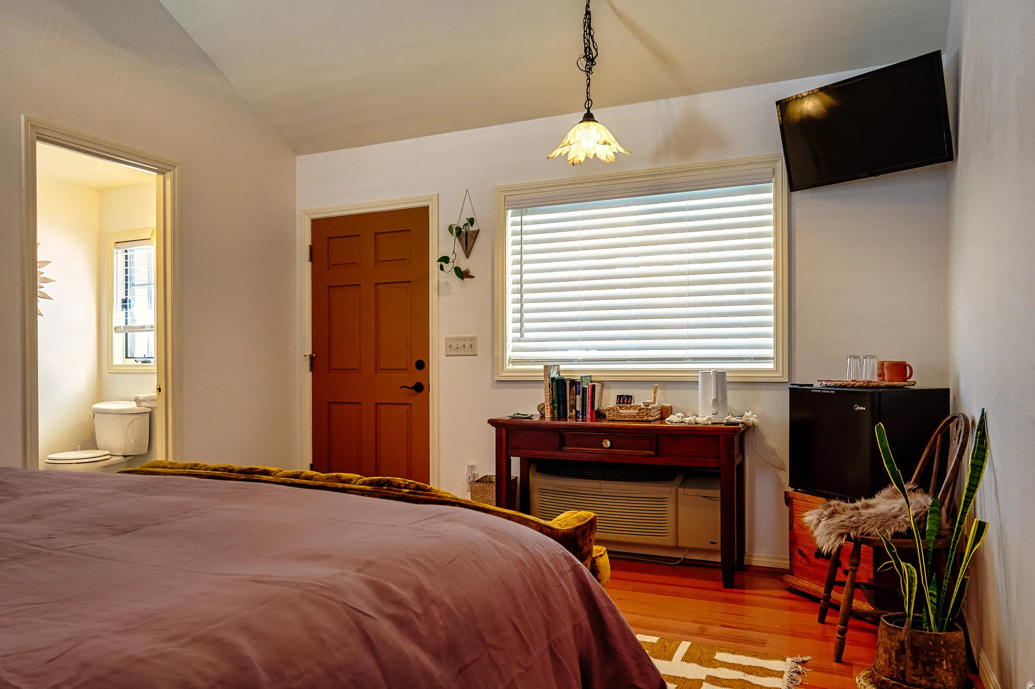 Bedroom featuring wood-type flooring and vaulted ceiling