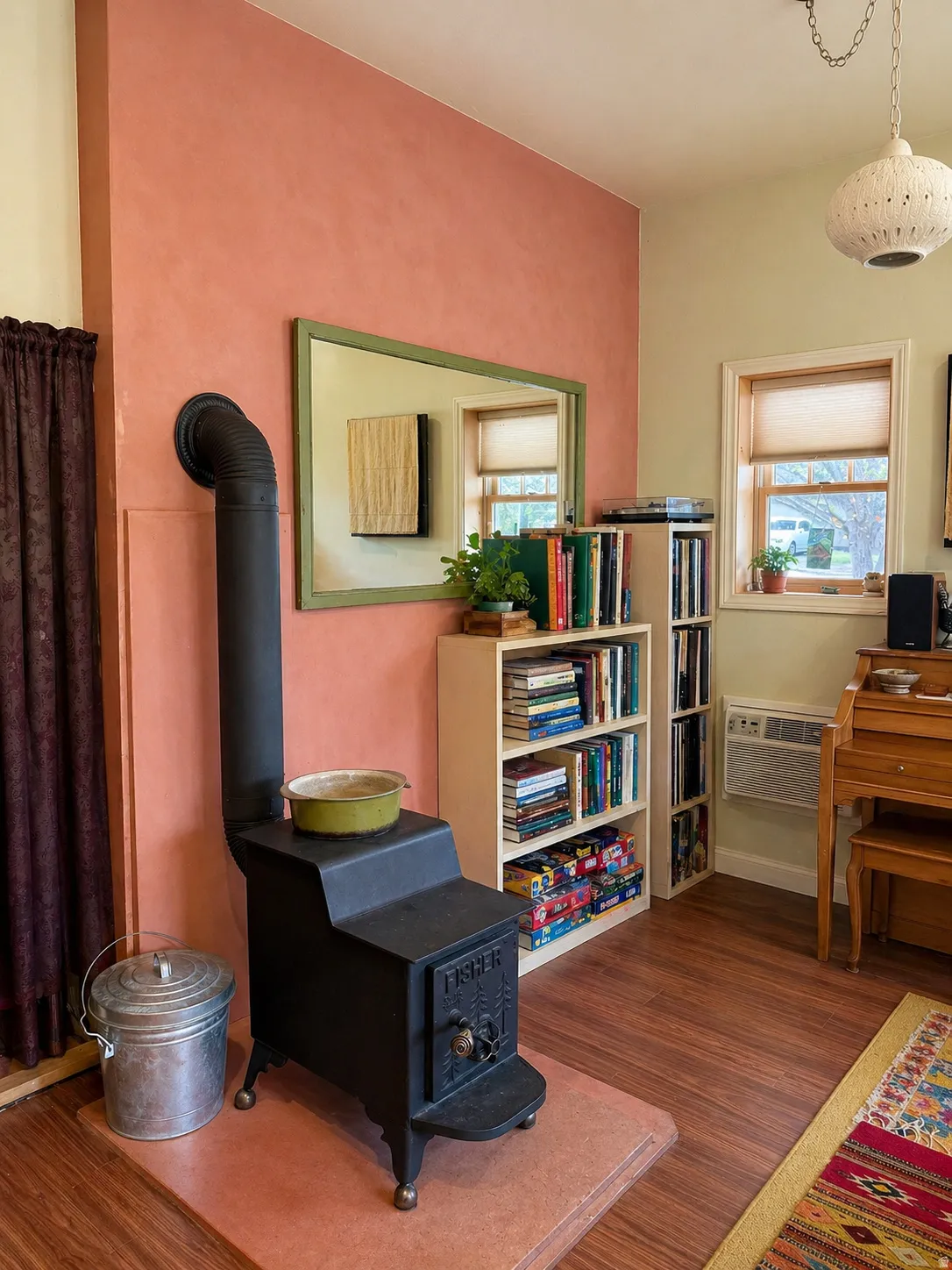 Living area with a wood stove, dark wood finished floors, and healthy amount of natural light