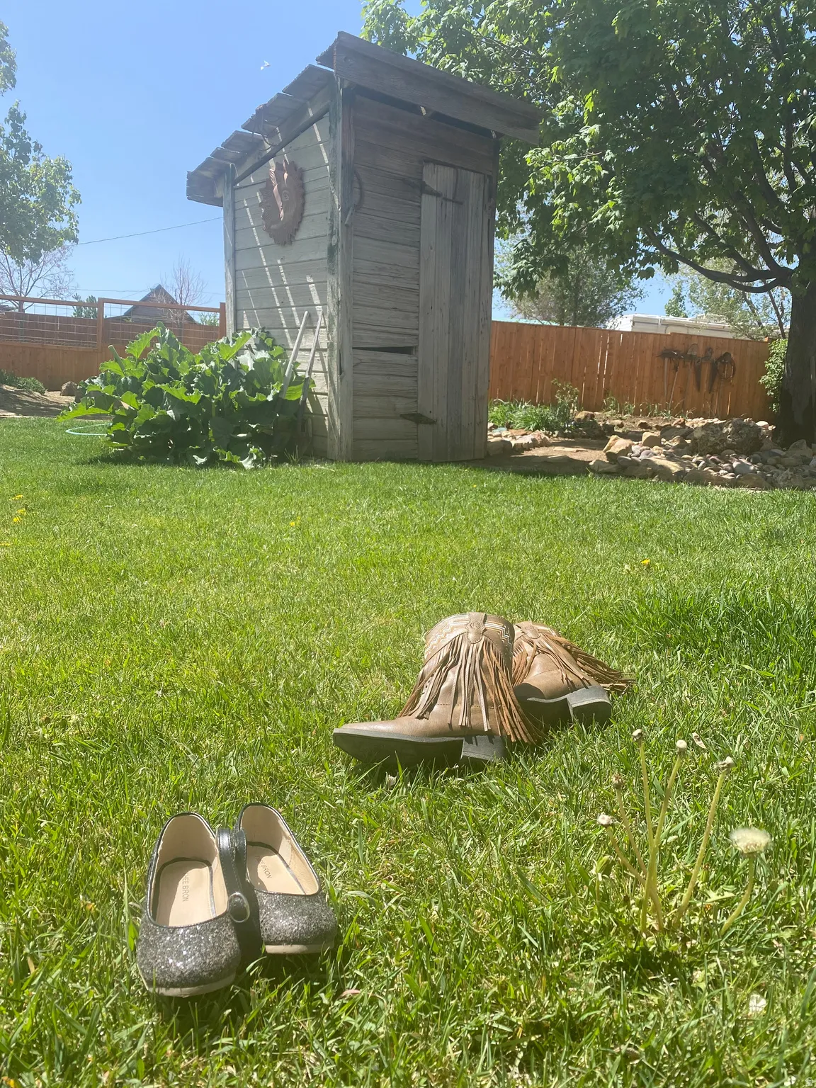 Fenced yard featuring a storage unit