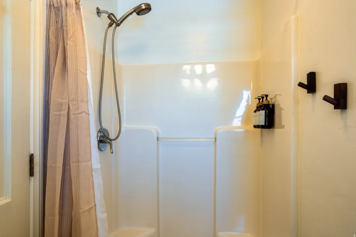 Bathroom with a shower with shower curtain