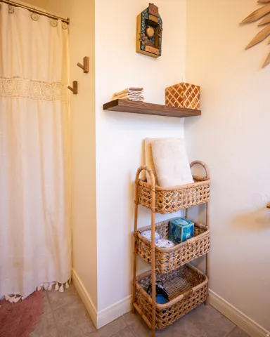 Bathroom with a shower with shower curtain and light tile patterned floors