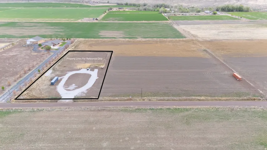 Aerial view of sparsely populated area with large plots for crops and property boundaries highlighted