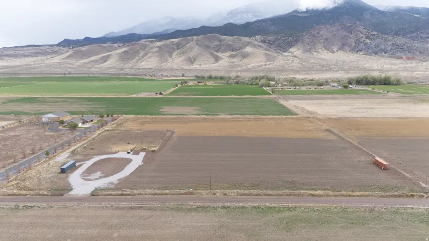 View of mountain backdrop with rural landscape and extensive farmland