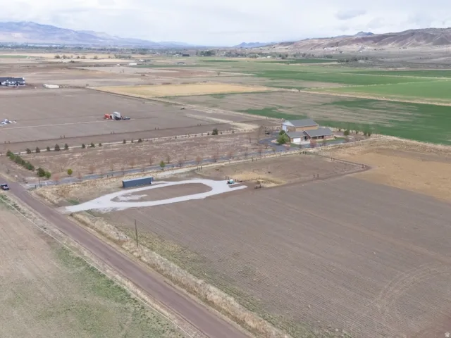 Aerial view of sparsely populated area with a mountainous background and abundant farmland
